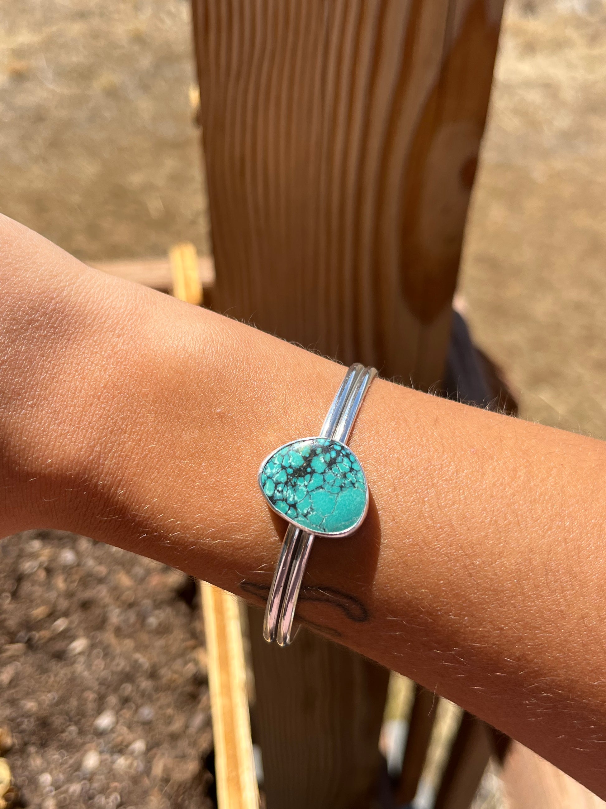 Turquoise bracelet on a wrist with a blurred background