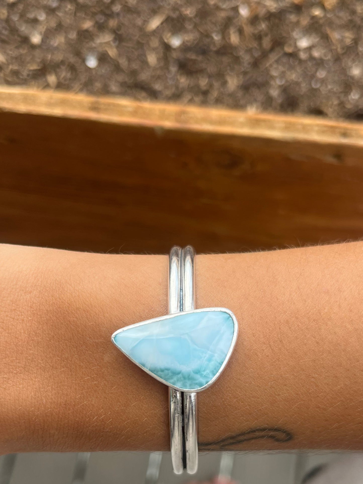 Larimar stone bracelet on a wrist with a blurred background