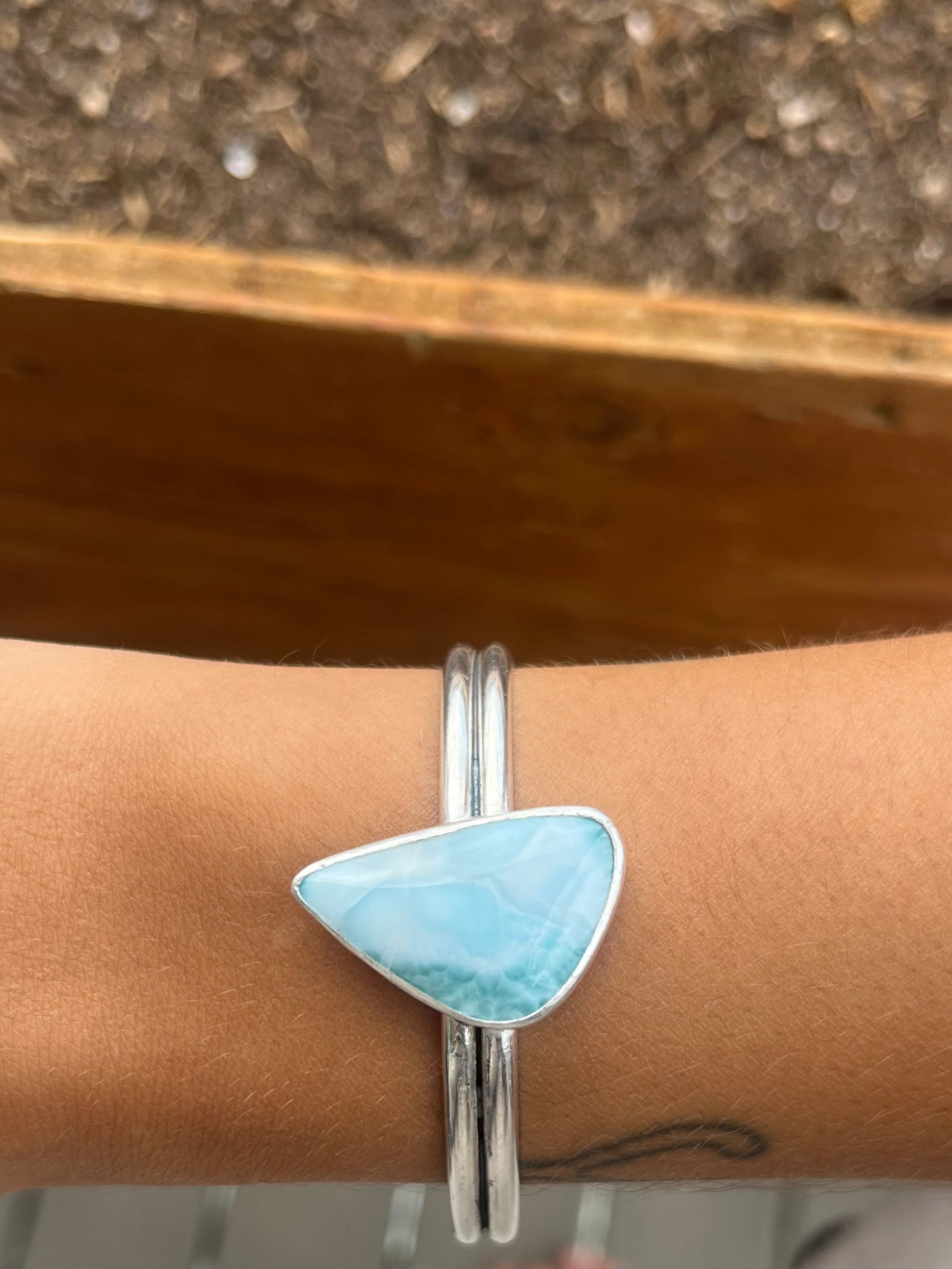 Larimar stone bracelet on a wrist with a blurred background